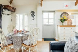 a dining room with a table and chairs at Lower Trowan Cottage in Sharnbrook