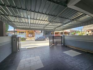an open garage with awning on a house at Ayaani Homestay in Kuala Pilah