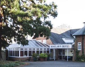 a building with a sign that reads maswegian hotel at Roselawn Hotel in Reading