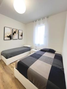 a bedroom with two beds and a window at Casa Umberto in Marghera