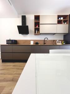 a kitchen with white cabinets and a sink at Casa Umberto in Marghera +27 photos