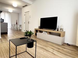 a living room with a flat screen tv on a white wall at Casa Umberto in Marghera