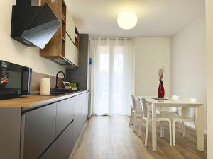 a kitchen with a table and chairs in a kitchen at Casa Umberto in Marghera