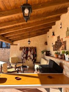 a living room with wooden ceilings and a table at Casa Rural Cristina in Morcuera
