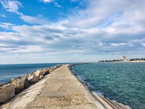 a stone pier stretches out into the ocean at Room Antonia in Umag