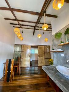 a bathroom with a sink and a dining room at PRECIOUS HOMESTAY - Cozy Room in Burgos