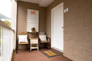 an exit sign on a wall next to a door at Harrison Lake Retreat, Studio Suite in Harrison Hot Springs