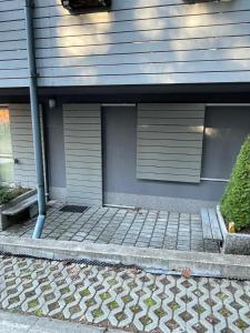 a house with two garage doors and a sidewalk at Apartman Harrachov - Resident in Harrachov +1 photo