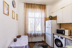 a kitchen with a white refrigerator and a window at Двухкомнатная евро двушка в самом центре Алматы, 10 минут ходьбы до Арбата #32 in Almaty