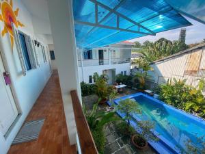 a view from the balcony of a house with a swimming pool at ღ Orchid Guesthouse ღ 5 minutes to the Beach & Night Market ღ in Phú Quốc
