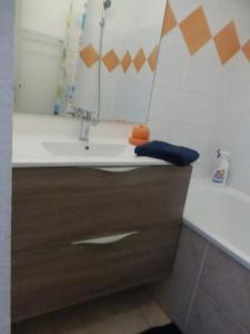 un bagno con un lavandino, uno specchio e una vasca di Appartement moderne à Montpellier, 45 m², climatisation a Montpellier