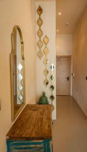 a room with a wooden table and a mirror at Churchill Townhouse in Bodrum City