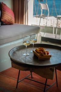 two glasses of wine and a tray of food on a table at Churchill Townhouse in Bodrum City