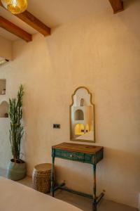 a dressing table with a mirror on a wall at Churchill Townhouse in Bodrum City