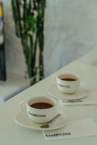 two cups of coffee sitting on a table at Churchill Townhouse in Bodrum City