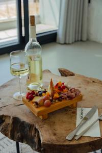 a plate of food and a bottle of wine on a table at Churchill Townhouse in Bodrum City