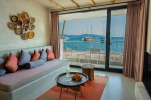 a living room with a couch and a view of the water at Churchill Townhouse in Bodrum City