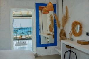 a room with a blue mirror and a table at Churchill Townhouse in Bodrum City
