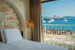 a room with a view of the ocean and a cruise ship at Churchill Townhouse in Bodrum City