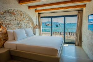 a bedroom with a bed with a view of the ocean at Churchill Townhouse in Bodrum City