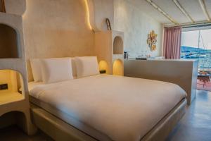 a bedroom with a large white bed in a room at Churchill Townhouse in Bodrum City