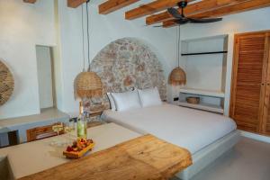 a bedroom with a bed and a table with fruit on it at Churchill Townhouse in Bodrum City