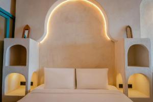a bedroom with a bed with two arches at Churchill Townhouse in Bodrum City