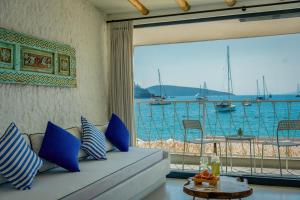 a living room with a couch and a view of the water at Churchill Townhouse in Bodrum City