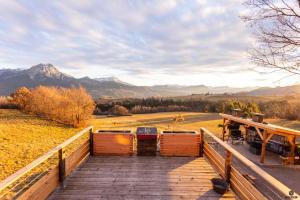a wooden boardwalk with a view of the mountains at Le refuge des Toupins in Prunières +21 photos