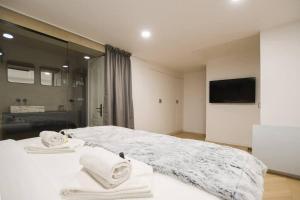 a bedroom with a white bed with towels on it at Bel appartement pour 6 personnes proche Champs Elysees in Paris
