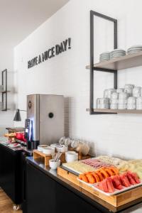 a kitchen with a bunch of food on a counter at DELPLAZA Timbiras São Paulo in São Paulo