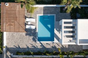 an overhead view of a swimming pool next to a building at Salty Sun Luxury Villas in Kremasti