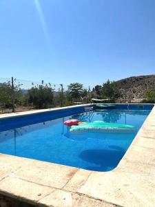 a large swimming pool with some inflatable at Casas de Vela in Vélez Blanco
