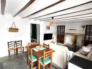 a living room with a table and a couch at Casas de Vela in Vélez Blanco