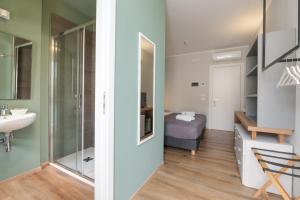 a bathroom with a sink and a mirror at Hotel Perla in Castiglione della Pescaia