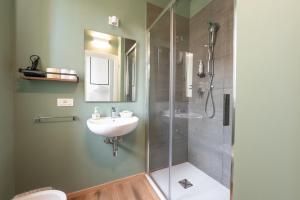 a bathroom with a shower and a sink at Hotel Perla in Castiglione della Pescaia