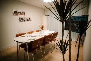 a table in a room with chairs and a plant at Gyeongju Record Stay Near tourist attractions in Gyeongju