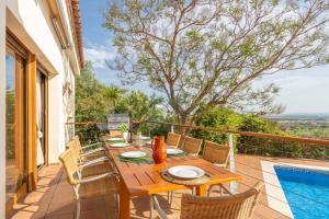 a patio with a table and chairs and a pool at V024 - Villa Colina in Palau-Saverdera