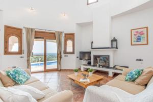 a living room with two couches and a fireplace at V024 - Villa Colina in Palau-Saverdera