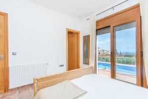 a bedroom with a bed and a view of a pool at V024 - Villa Colina in Palau-Saverdera +46 photos