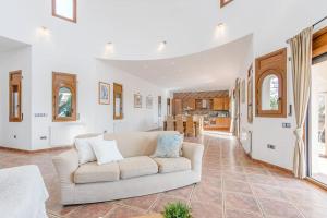 a living room with a white couch and a kitchen at V024 - Villa Colina in Palau-Saverdera