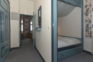 a small room with a bunk bed and a hallway at Haus Poggfred Whg 03 Harcken in Wyk auf Föhr