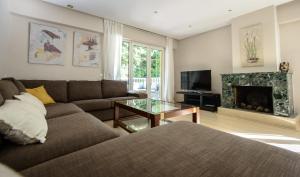 a living room with a couch and a fireplace at Calandria Madrid in Madrid