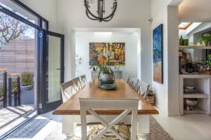 a dining room with a wooden table and chairs at Home for 8 in central Green Point in Cape Town