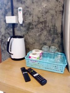 a table with a coffee maker and a remote control at Hubkhao Resort in Ko Lanta