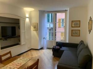 a living room with a couch and a large window at Cernaia by Farris & Cors in Genova