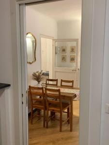 a dining room with a table and chairs at Cernaia by Farris & Cors in Genova +7 photos