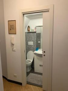 a bathroom with a toilet and a sink at Cernaia by Farris & Cors in Genova