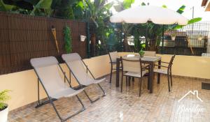 a table and chairs sitting on a patio at Brooklyn&Fennel House in Funchal