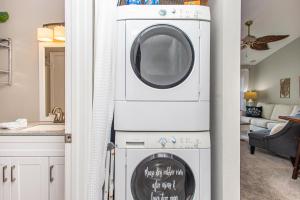 a washer and dryer with a sign on the door at Baywatch D11 in Pensacola Beach